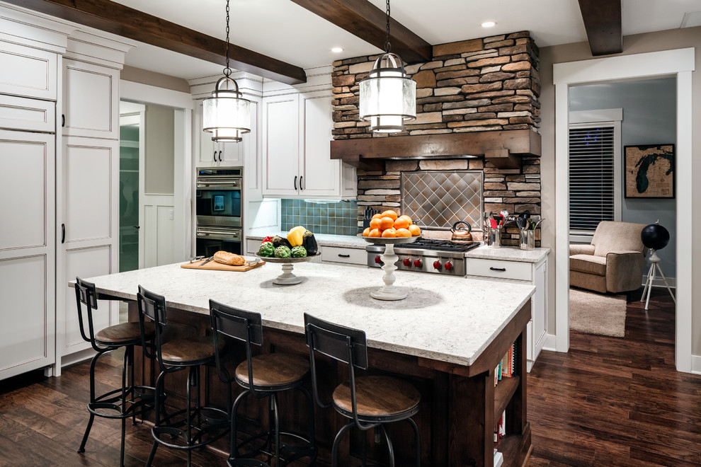 Example of a mid-sized mountain style u-shaped medium tone wood floor eat-in kitchen design in Grand Rapids with an undermount sink, recessed-panel cabinets, white cabinets, quartzite countertops, blue backsplash, ceramic backsplash, stainless steel appliances and an island
