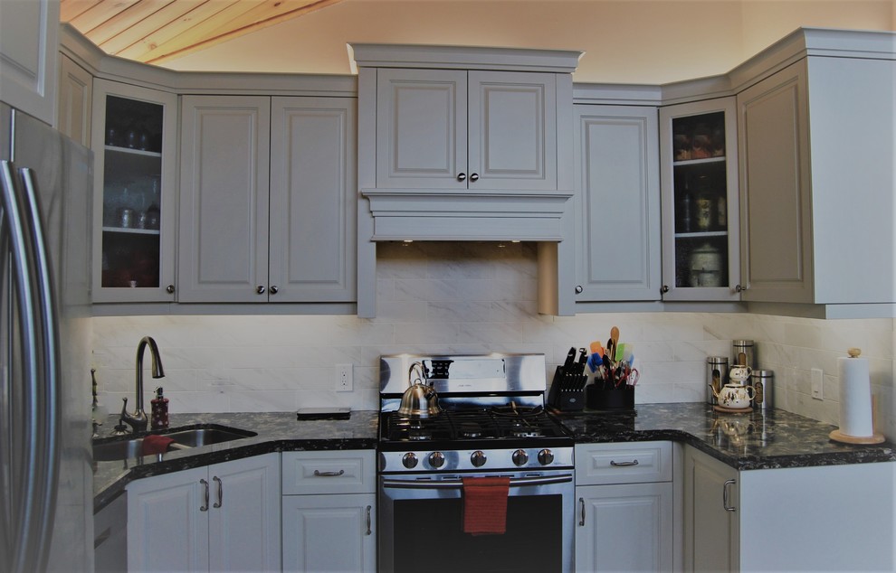 Inspiration för ett mellanstort funkis kök, med en undermonterad diskho, luckor med upphöjd panel, vita skåp, bänkskiva i kvartsit, grått stänkskydd, stänkskydd i porslinskakel, rostfria vitvaror, klinkergolv i keramik och en köksö