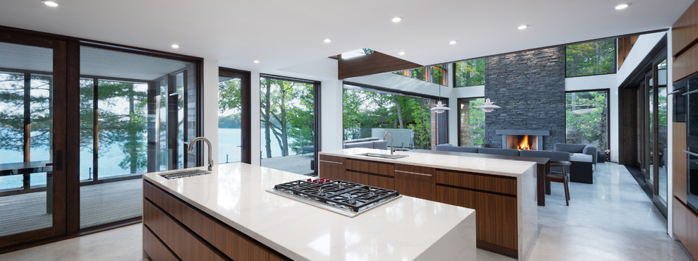 Inspiration for a contemporary open plan kitchen in Other with medium wood cabinets, marble worktops, stainless steel appliances, concrete flooring, multiple islands, grey floors and white worktops.