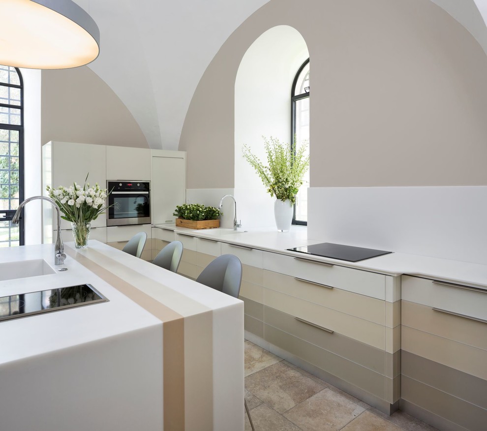 Large contemporary u-shaped enclosed kitchen in Other with an integrated sink, glass-front cabinets, white cabinets, engineered stone countertops, white splashback, integrated appliances, porcelain flooring and an island.