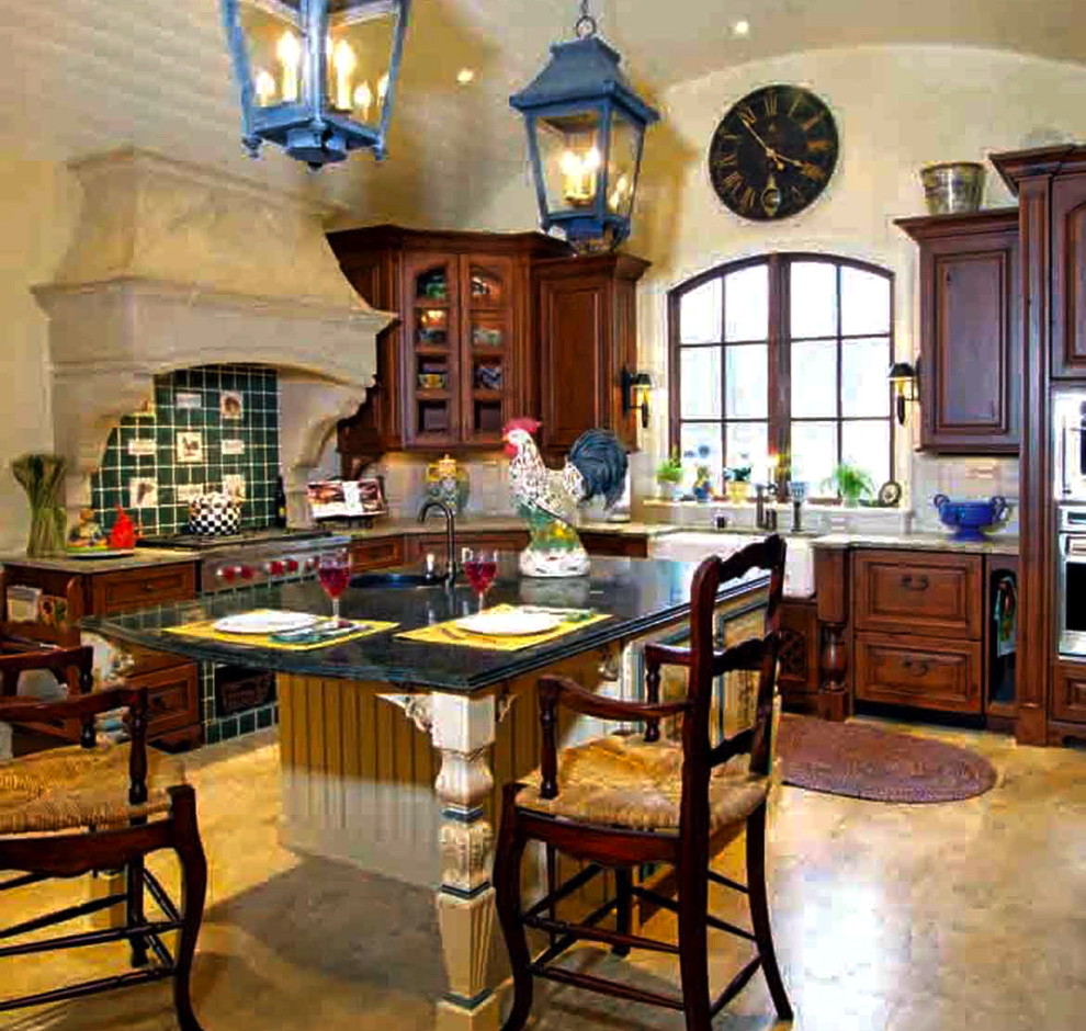 Mid-sized elegant l-shaped travertine floor enclosed kitchen photo in Louisville with a farmhouse sink, raised-panel cabinets, medium tone wood cabinets, granite countertops, white backsplash, ceramic backsplash, stainless steel appliances and an island