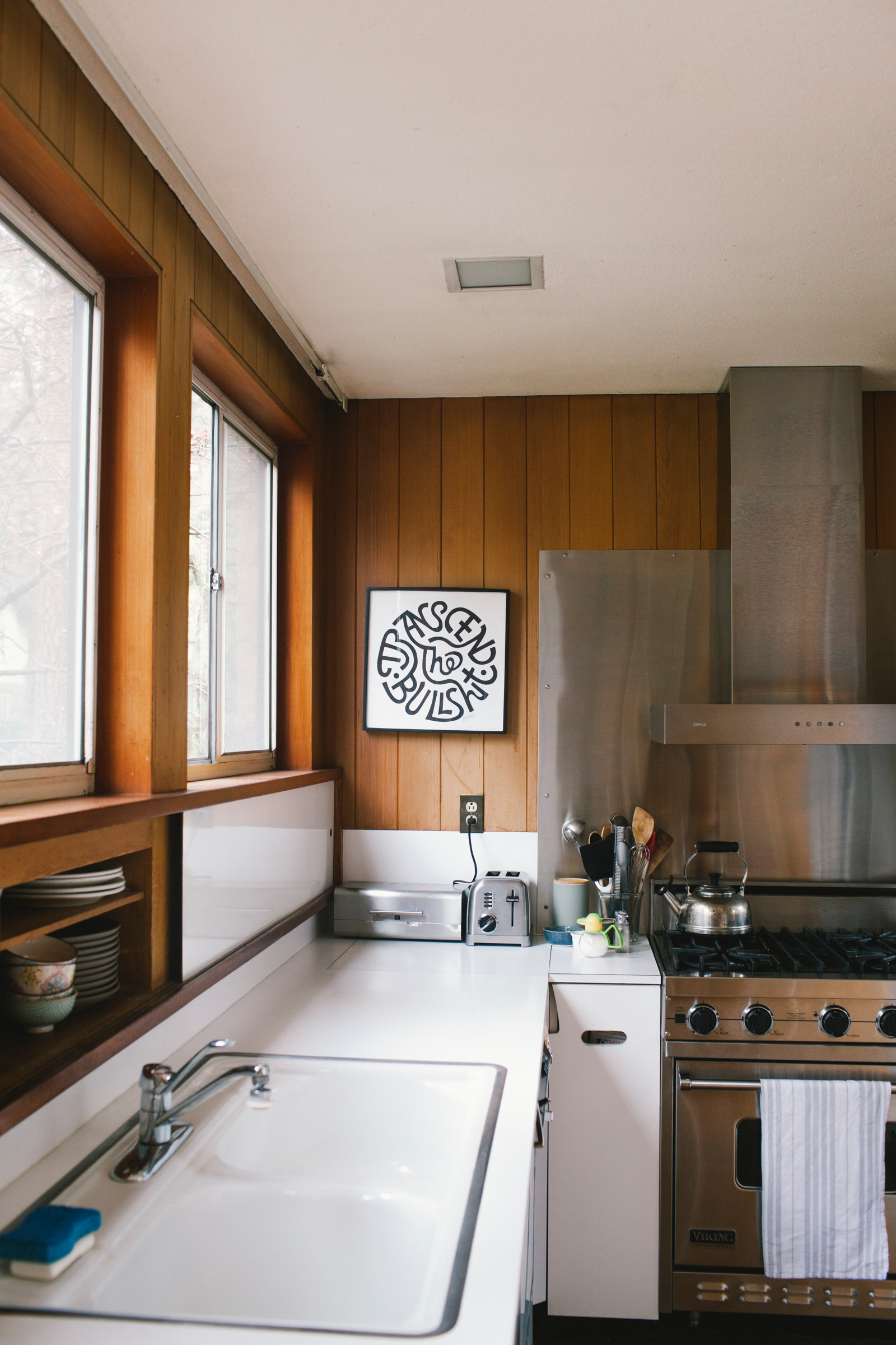 Modern take on a galley kitchen, love the Viking stove.