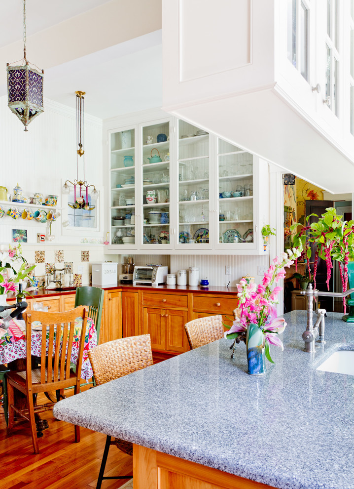 Eat-in kitchen - eclectic eat-in kitchen idea in Boston with glass-front cabinets, white cabinets and multicolored backsplash