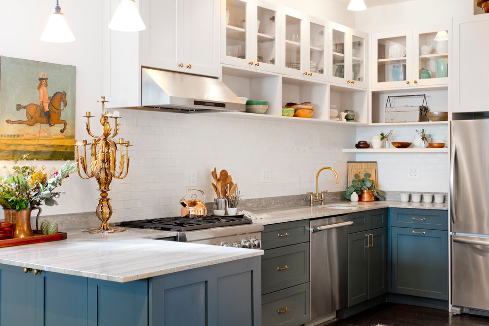 Transitional u-shaped dark wood floor open concept kitchen photo in New York with blue cabinets, white backsplash, stainless steel appliances, a peninsula, an undermount sink and shaker cabinets