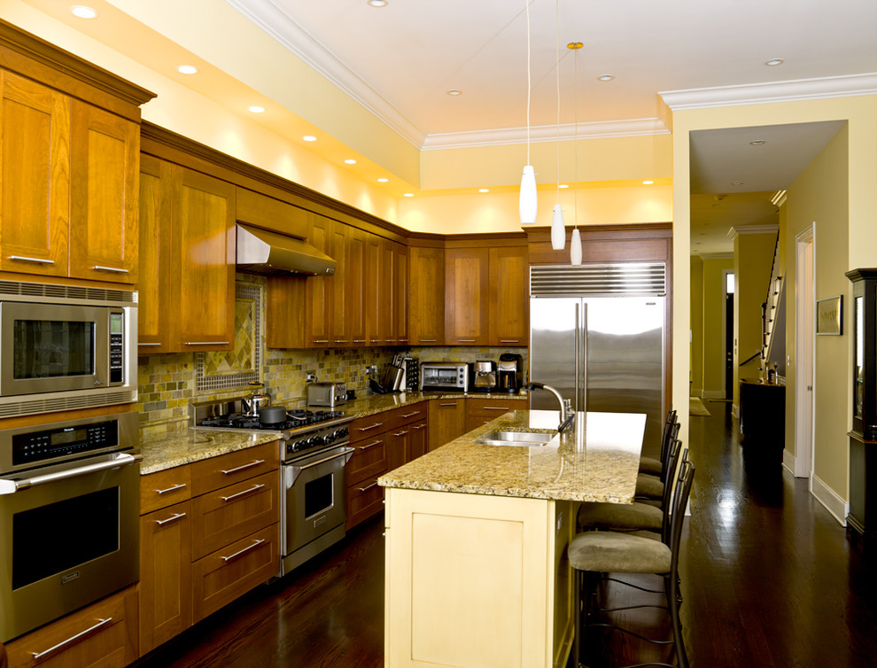 Example of a classic kitchen design in Chicago with stainless steel appliances and slate backsplash