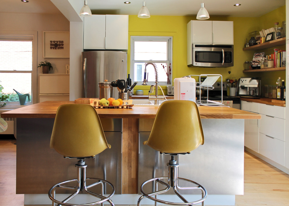 Foto di una cucina eclettica con lavello da incasso, ante lisce, ante bianche, top in legno e elettrodomestici bianchi
