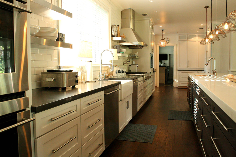 Inspiration for a transitional kitchen remodel in Tampa with a farmhouse sink, white backsplash, subway tile backsplash and stainless steel appliances