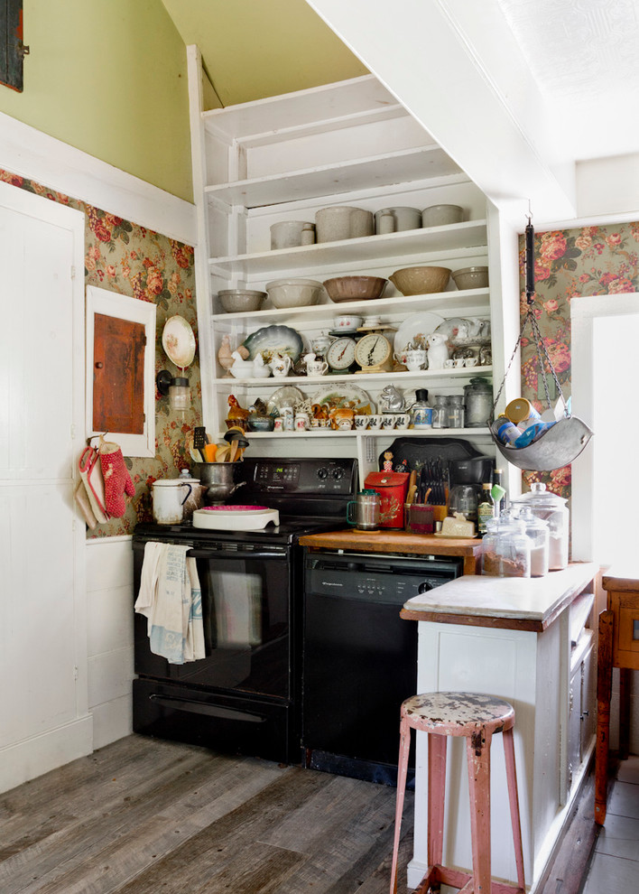 Inspiration for a small vintage kitchen in New York with open cabinets, white cabinets, wood worktops, black appliances, a breakfast bar and dark hardwood flooring.