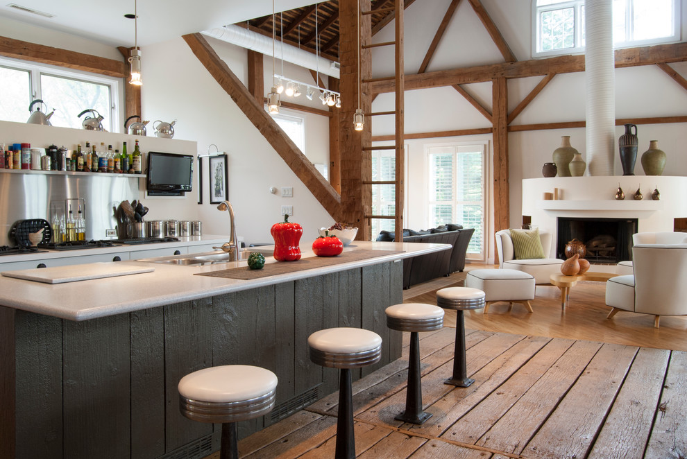 Example of a huge farmhouse galley medium tone wood floor open concept kitchen design in Cleveland with metallic backsplash, metal backsplash, an island, a double-bowl sink, flat-panel cabinets, white cabinets, solid surface countertops and stainless steel appliances