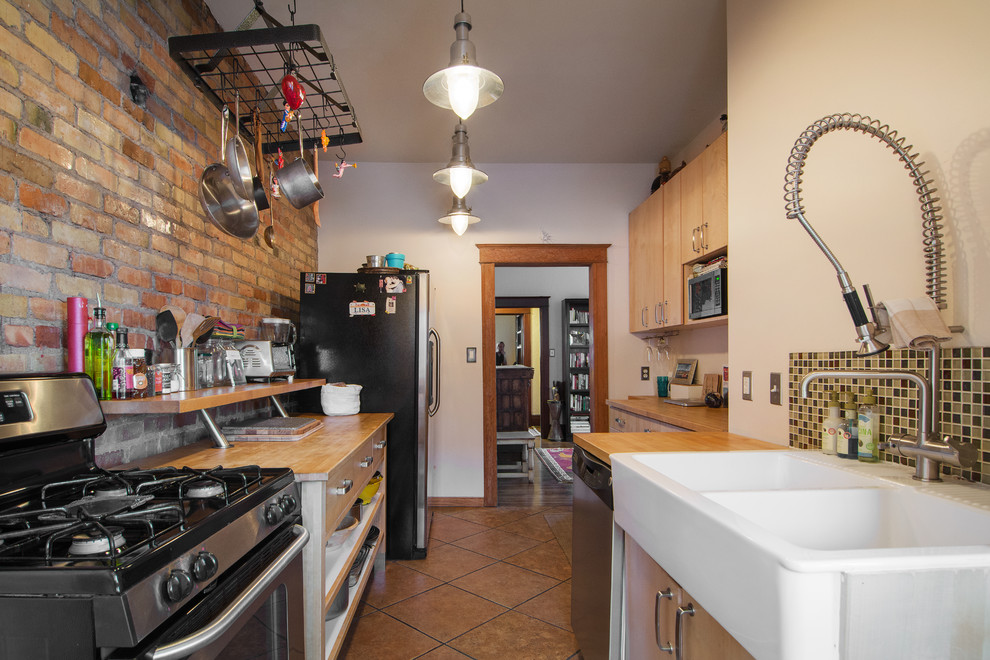 Bohemian galley enclosed kitchen in Salt Lake City with a belfast sink, open cabinets, medium wood cabinets, wood worktops, mosaic tiled splashback and stainless steel appliances.
