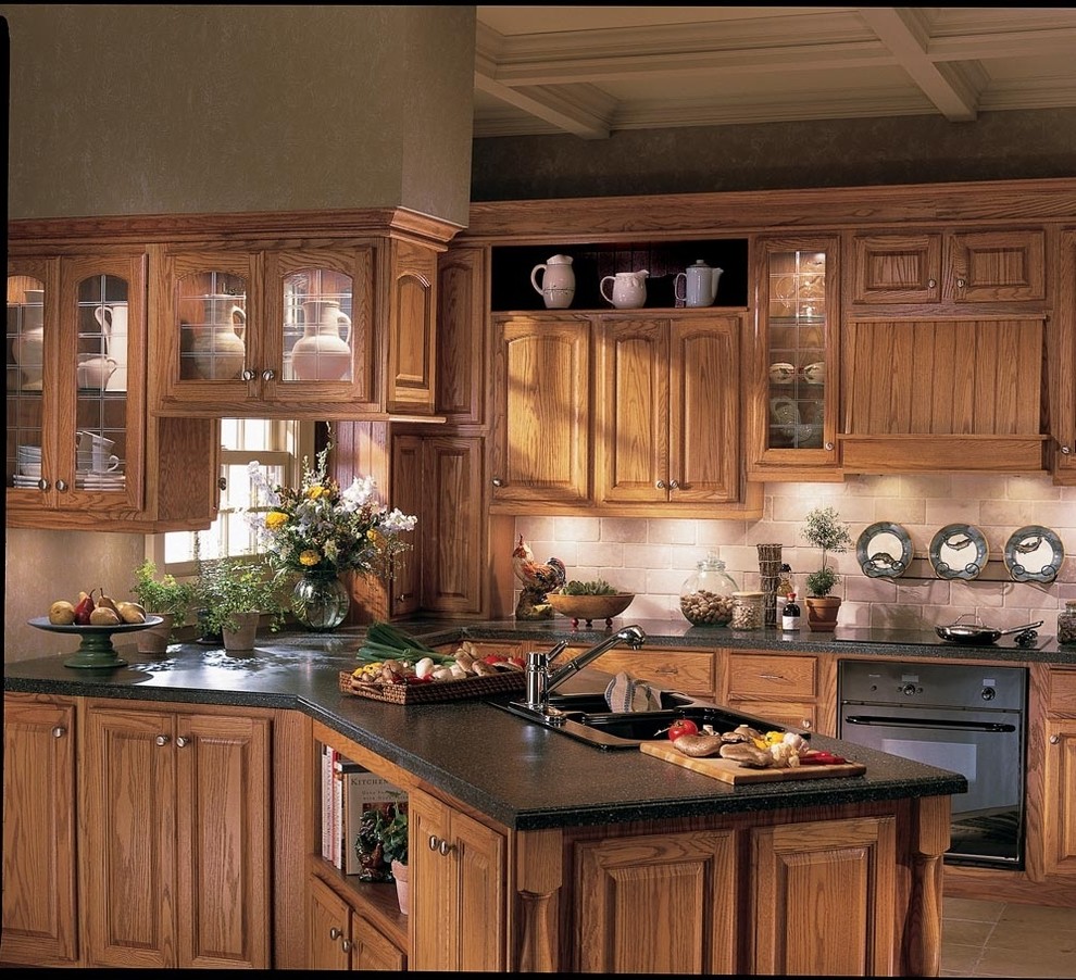 Eat-in kitchen - large traditional u-shaped ceramic tile eat-in kitchen idea in Other with a double-bowl sink, raised-panel cabinets, medium tone wood cabinets, granite countertops, beige backsplash, subway tile backsplash, black appliances and a peninsula