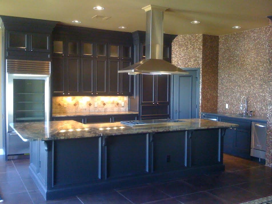 Example of a mid-sized trendy kitchen design in Oklahoma City with a double-bowl sink, beaded inset cabinets, dark wood cabinets, marble countertops, beige backsplash, stainless steel appliances and an island
