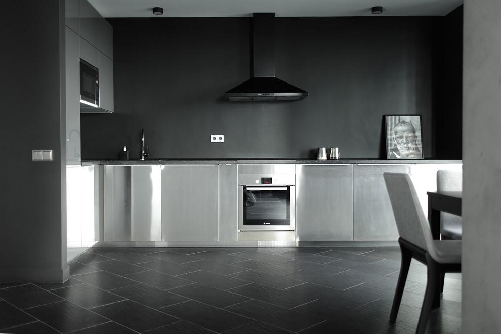 Inspiration for a medium sized industrial kitchen in Moscow with porcelain flooring and black floors.