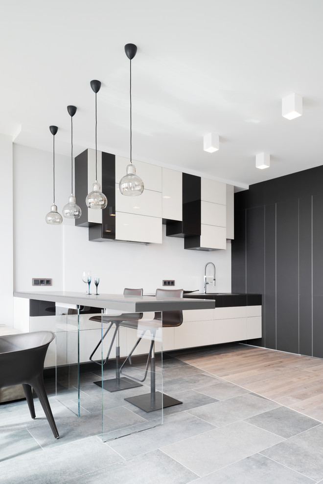Inspiration for a contemporary l-shaped open plan kitchen in Other with flat-panel cabinets, white cabinets, a breakfast bar and white splashback.