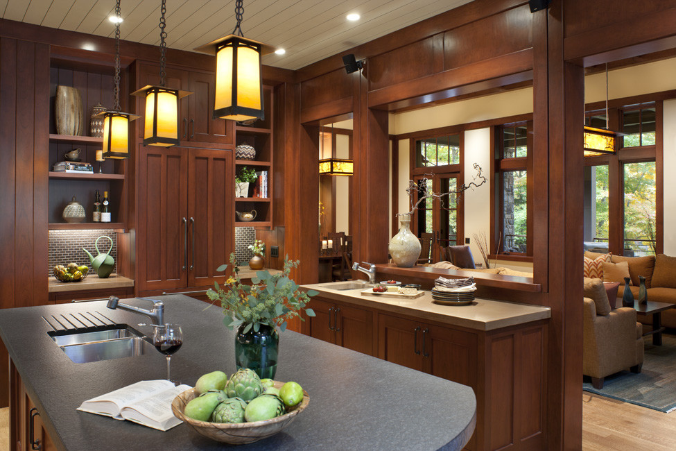 Inspiration for a mid-sized timeless galley light wood floor and brown floor enclosed kitchen remodel in Other with an undermount sink, recessed-panel cabinets, medium tone wood cabinets, two islands and stainless steel appliances