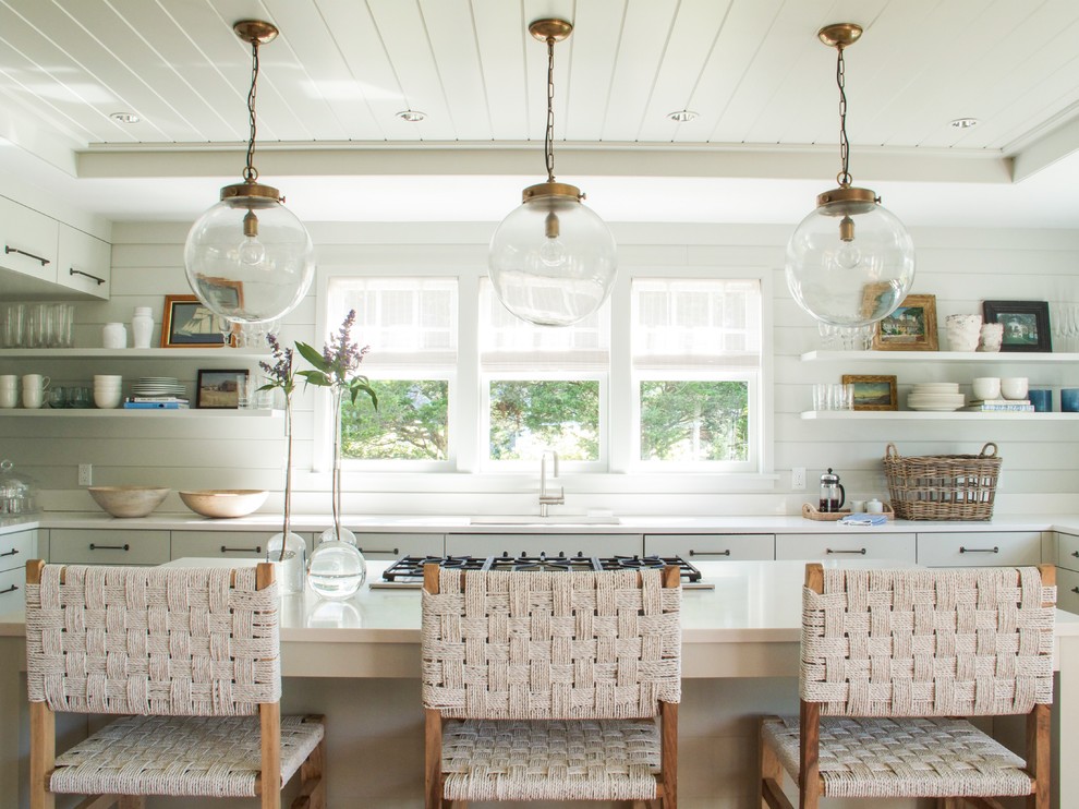 Kitchen - coastal u-shaped kitchen idea in Charleston with an undermount sink, open cabinets, white cabinets and an island