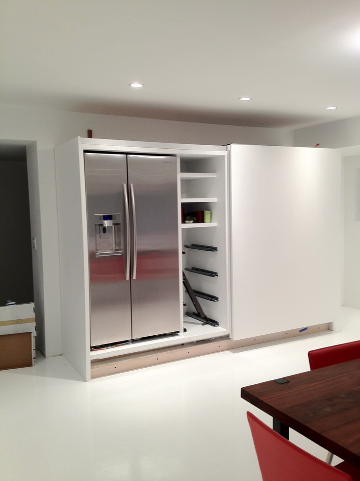Example of a minimalist white floor kitchen design in San Francisco with stainless steel appliances