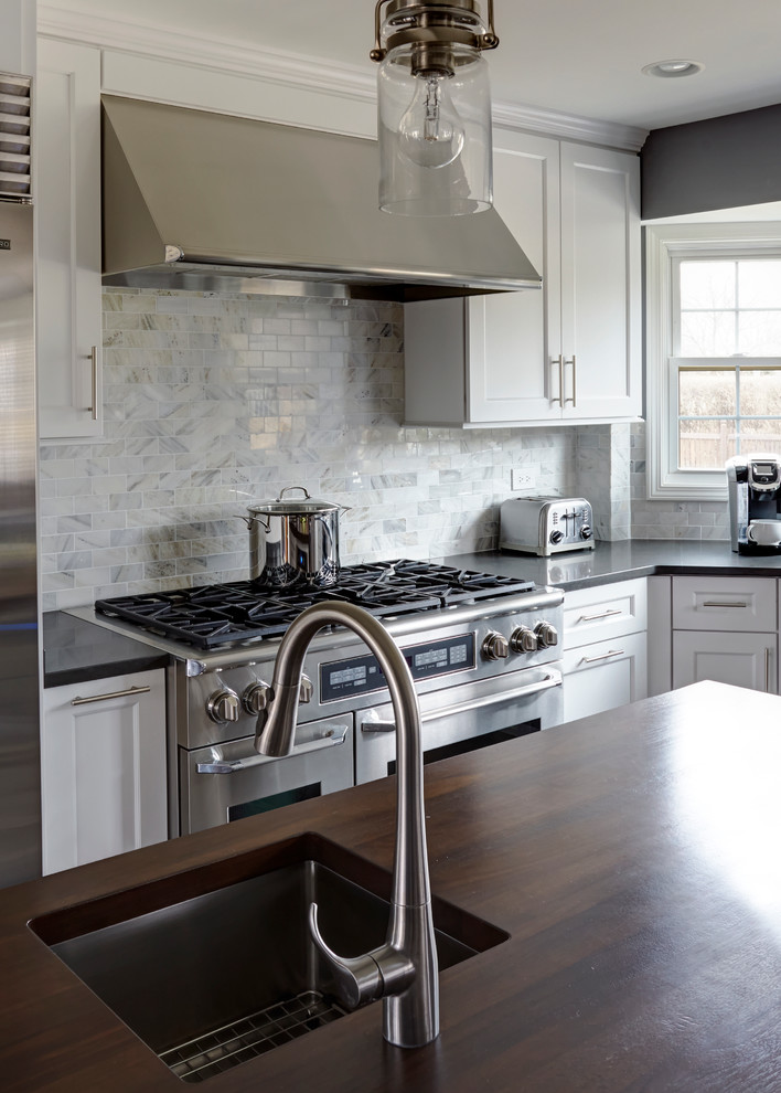 Eat-in kitchen - large transitional dark wood floor eat-in kitchen idea in Chicago with a single-bowl sink, shaker cabinets, white cabinets, quartz countertops, white backsplash, stone tile backsplash, stainless steel appliances and two islands