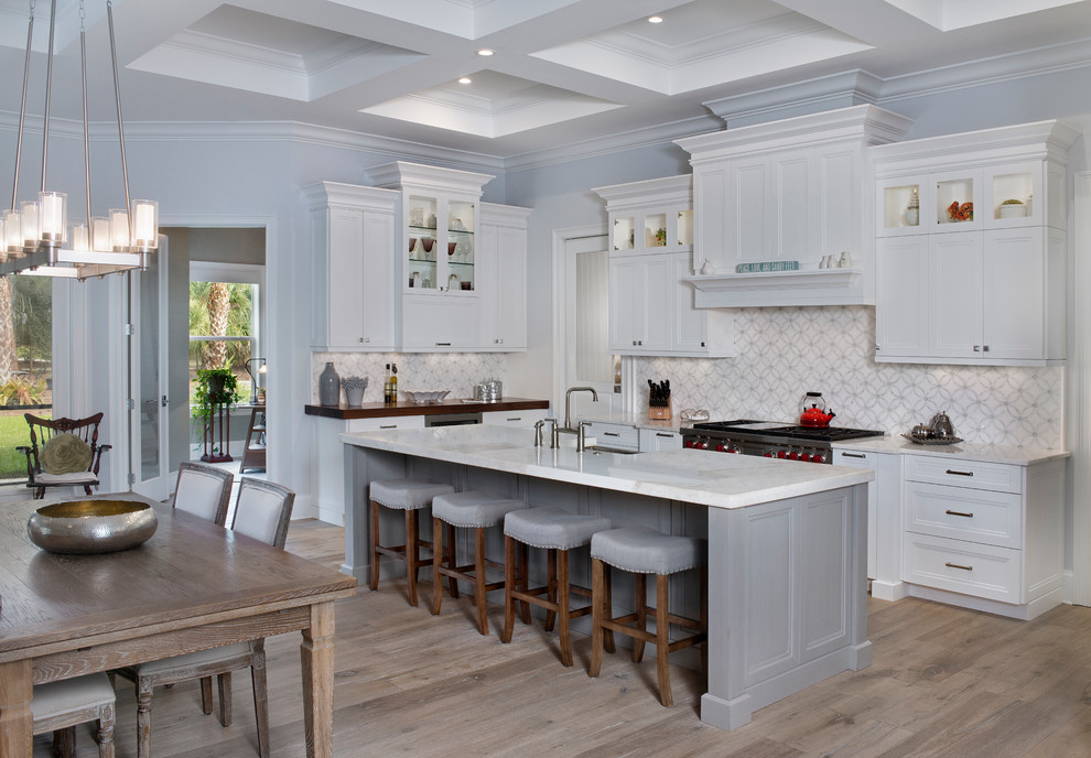 Exempel på ett mellanstort klassiskt vit vitt kök med öppen planlösning, med en rustik diskho, luckor med infälld panel, vita skåp, bänkskiva i kvarts, vitt stänkskydd, stänkskydd i cementkakel, rostfria vitvaror, mellanmörkt trägolv, en köksö och brunt golv