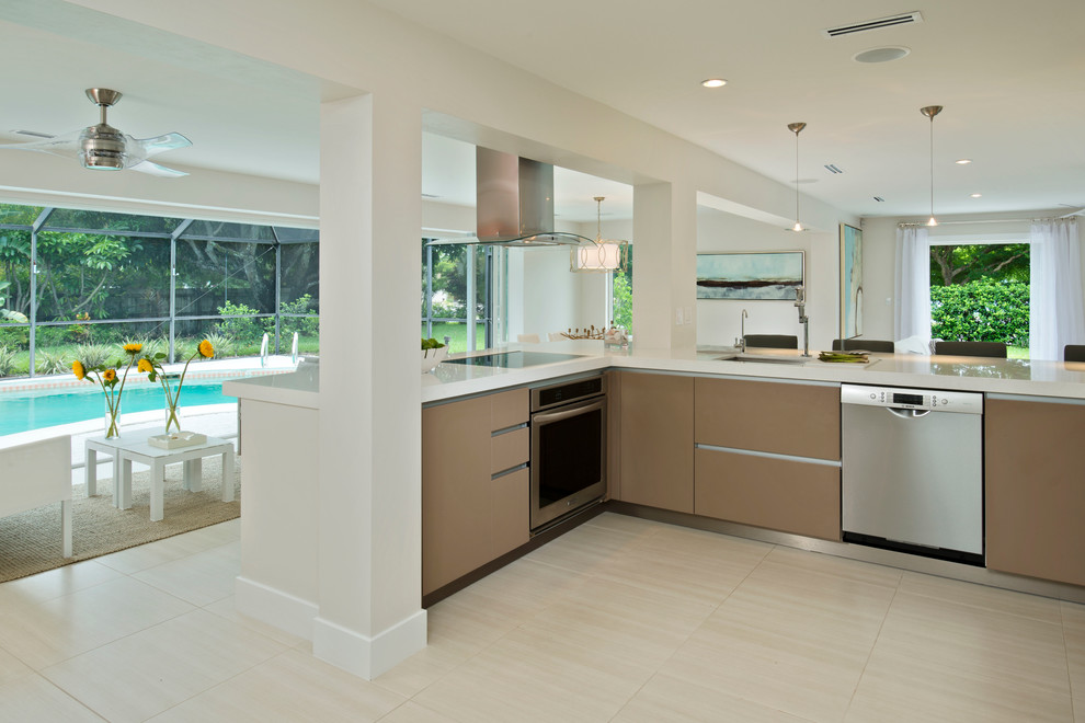 Medium sized contemporary u-shaped kitchen/diner in Miami with a submerged sink, flat-panel cabinets, brown cabinets, granite worktops, stainless steel appliances, ceramic flooring and beige floors.