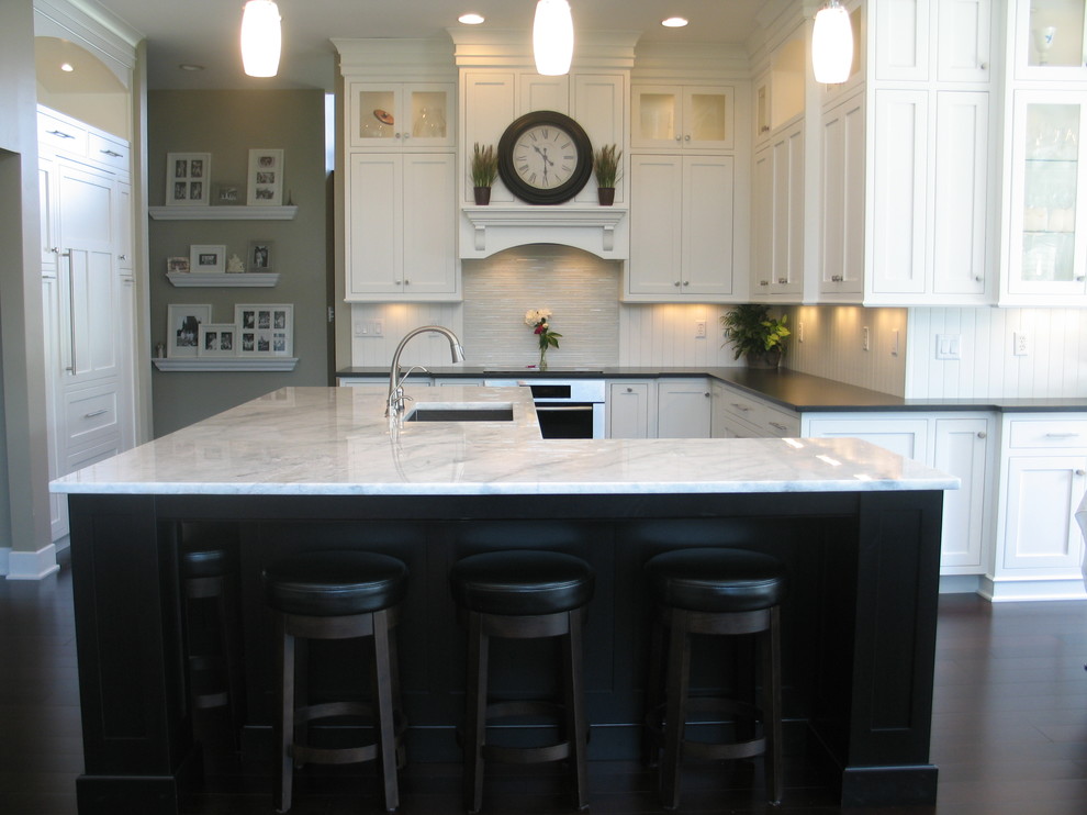 Large transitional l-shaped dark wood floor eat-in kitchen photo in Indianapolis with an undermount sink, recessed-panel cabinets, white cabinets, laminate countertops, white backsplash, ceramic backsplash, stainless steel appliances and an island