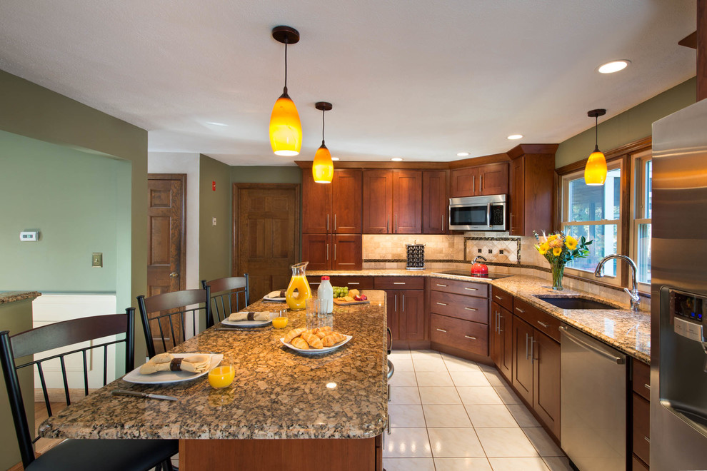Example of a classic single-wall ceramic tile eat-in kitchen design in Manchester with a single-bowl sink, flat-panel cabinets, medium tone wood cabinets, granite countertops, multicolored backsplash, ceramic backsplash, stainless steel appliances and an island