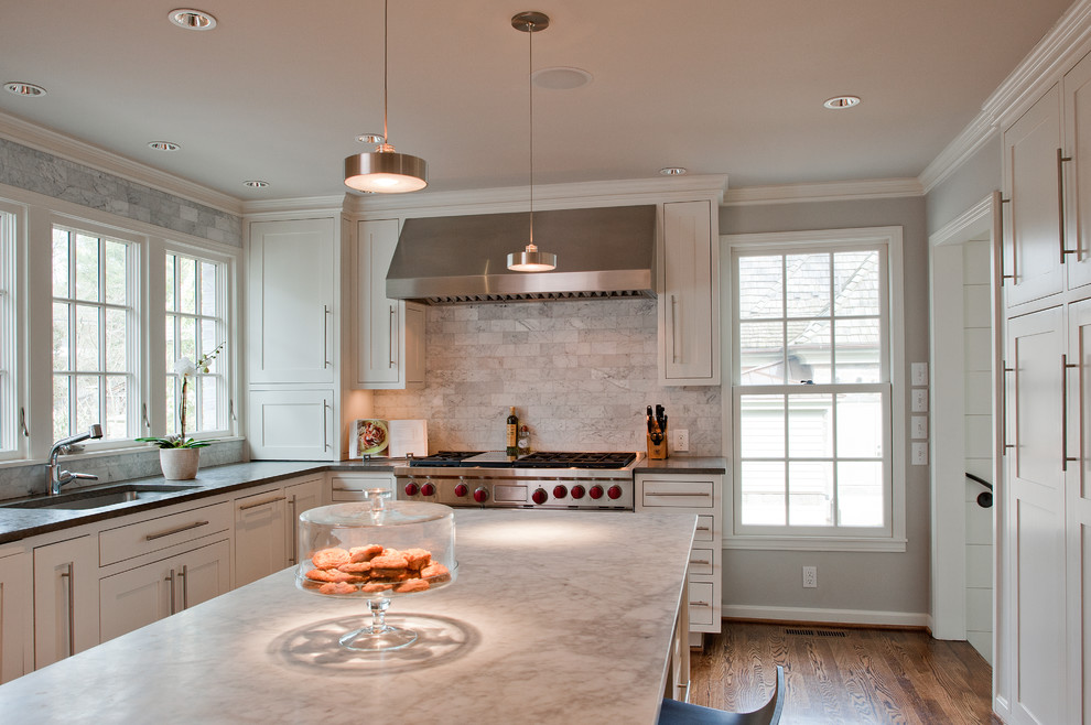 Elegant l-shaped eat-in kitchen photo in Nashville with an undermount sink, flat-panel cabinets, white cabinets, marble countertops, white backsplash and stainless steel appliances