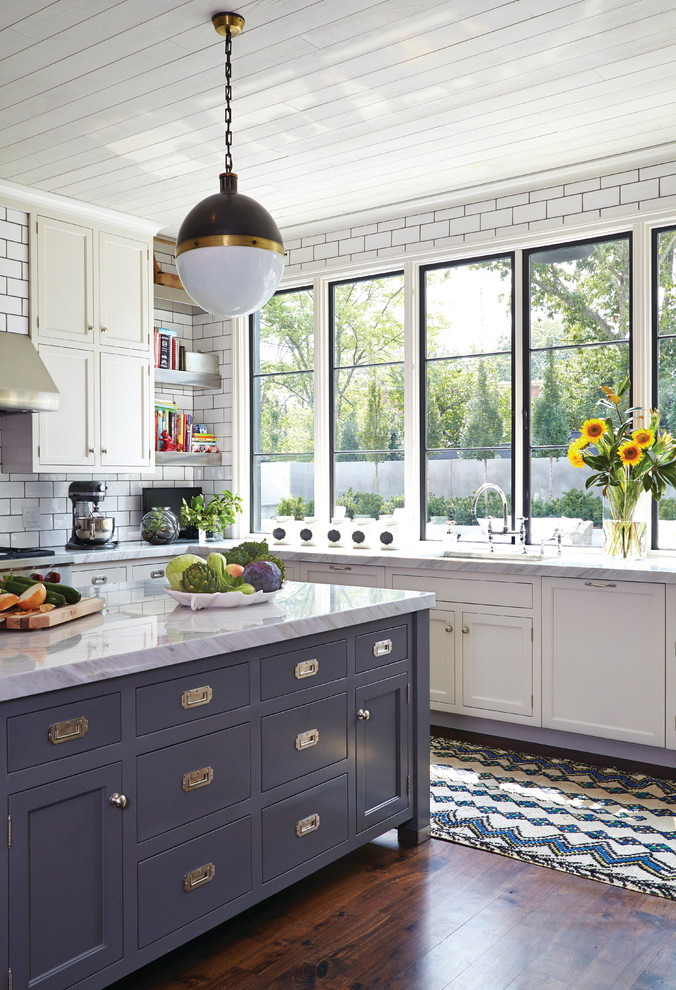 Kitchen - transitional dark wood floor kitchen idea in Nashville with shaker cabinets, white cabinets, white backsplash, subway tile backsplash, an island and white countertops