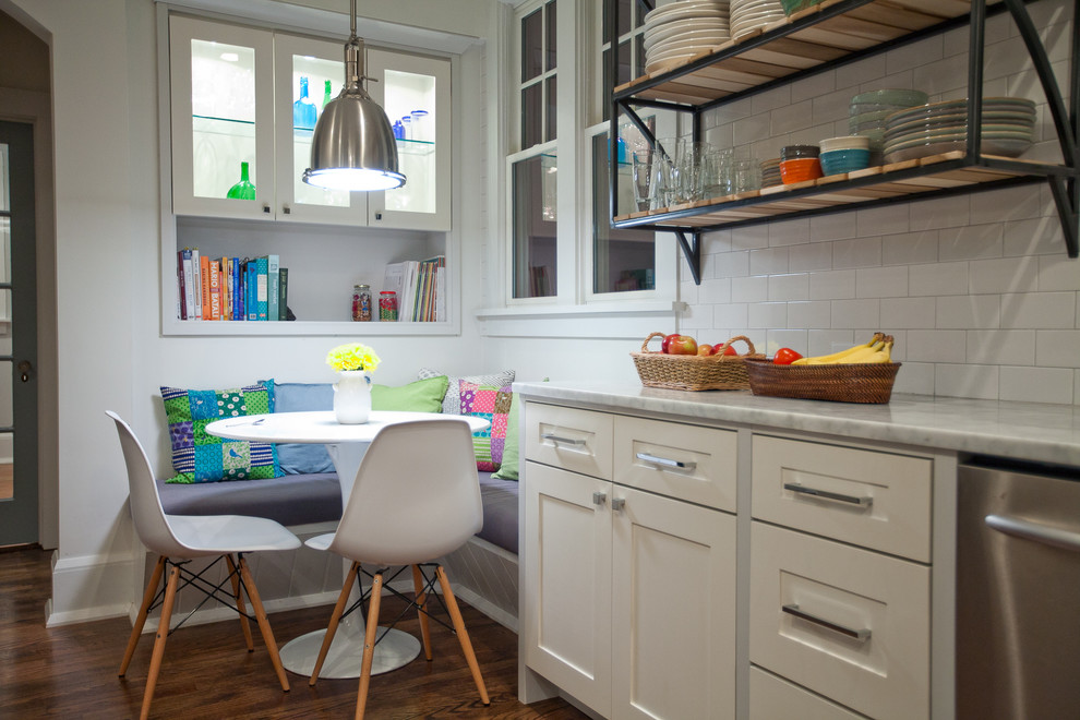 Example of a large trendy galley medium tone wood floor kitchen design in New York with an undermount sink, shaker cabinets, white cabinets, marble countertops, white backsplash, stainless steel appliances and an island