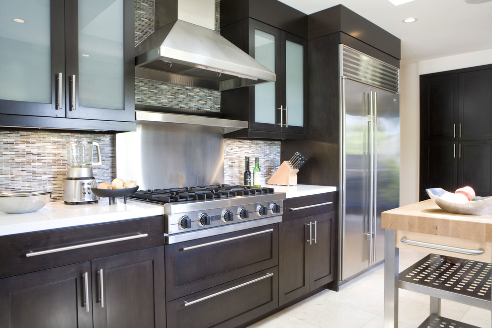 Inspiration for a contemporary kitchen remodel in Los Angeles with glass-front cabinets, dark wood cabinets, multicolored backsplash, matchstick tile backsplash and stainless steel appliances