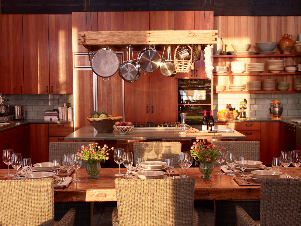 Стильный дизайн: кухня в современном стиле с плоскими фасадами, обеденным столом, фартуком из плитки кабанчик, темными деревянными фасадами и техникой под мебельный фасад - последний тренд