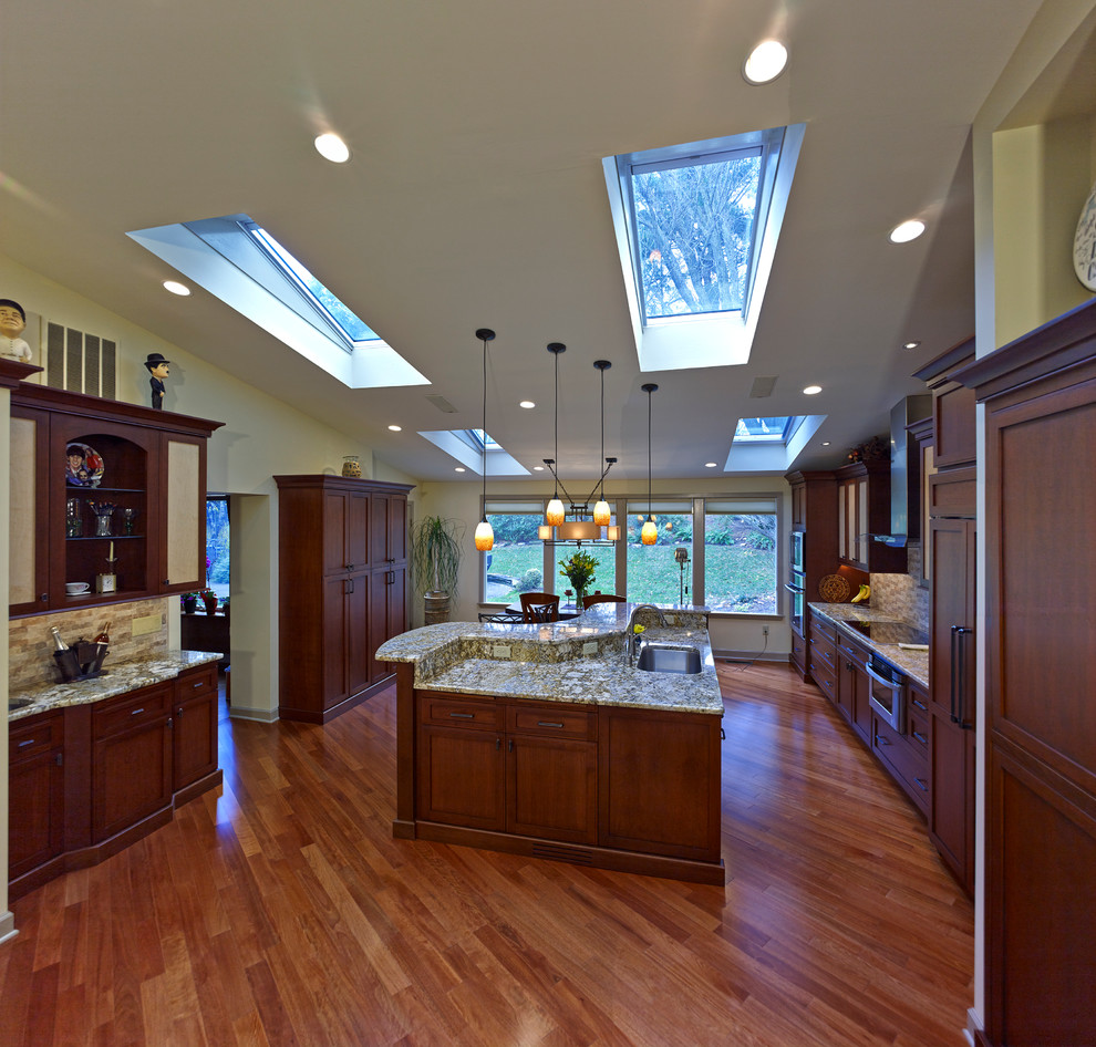 Example of a huge transitional single-wall painted wood floor open concept kitchen design in Philadelphia with flat-panel cabinets, medium tone wood cabinets, multicolored backsplash and an island