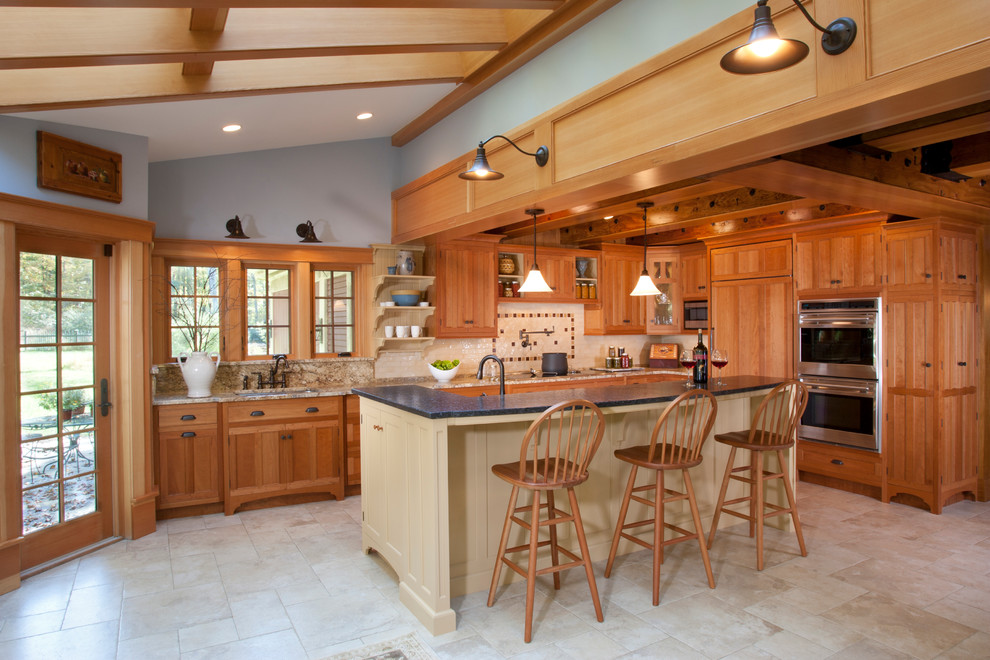Large arts and crafts l-shaped ceramic tile and beige floor eat-in kitchen photo in Other with an undermount sink, medium tone wood cabinets, granite countertops, yellow backsplash, ceramic backsplash, paneled appliances, an island and recessed-panel cabinets