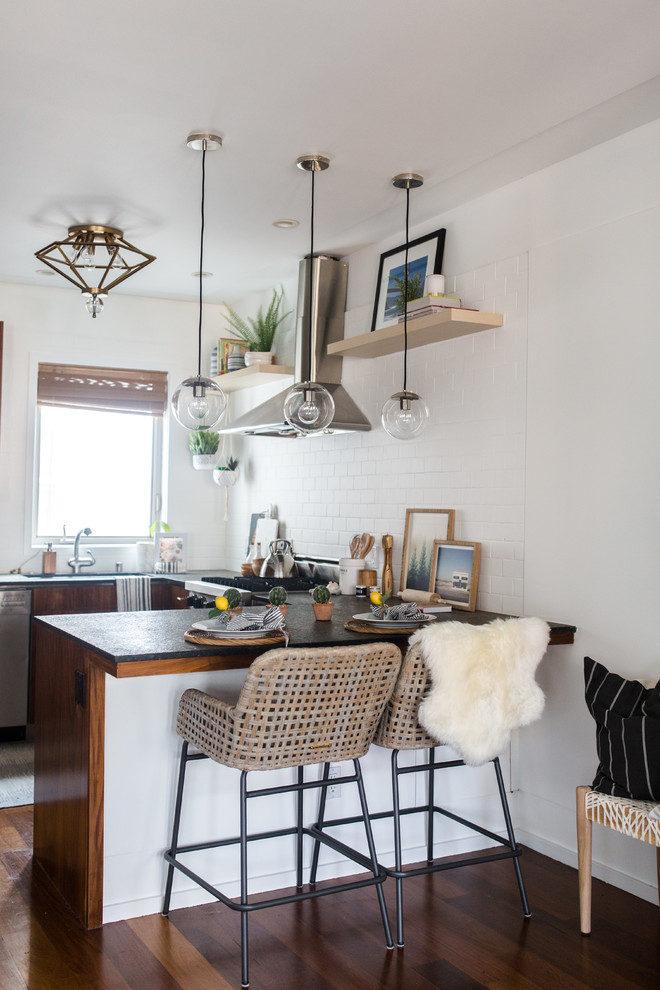 Example of a mid-sized eclectic l-shaped dark wood floor and brown floor open concept kitchen design in San Francisco with a single-bowl sink, flat-panel cabinets, brown cabinets, concrete countertops, white backsplash, subway tile backsplash, stainless steel appliances and an island