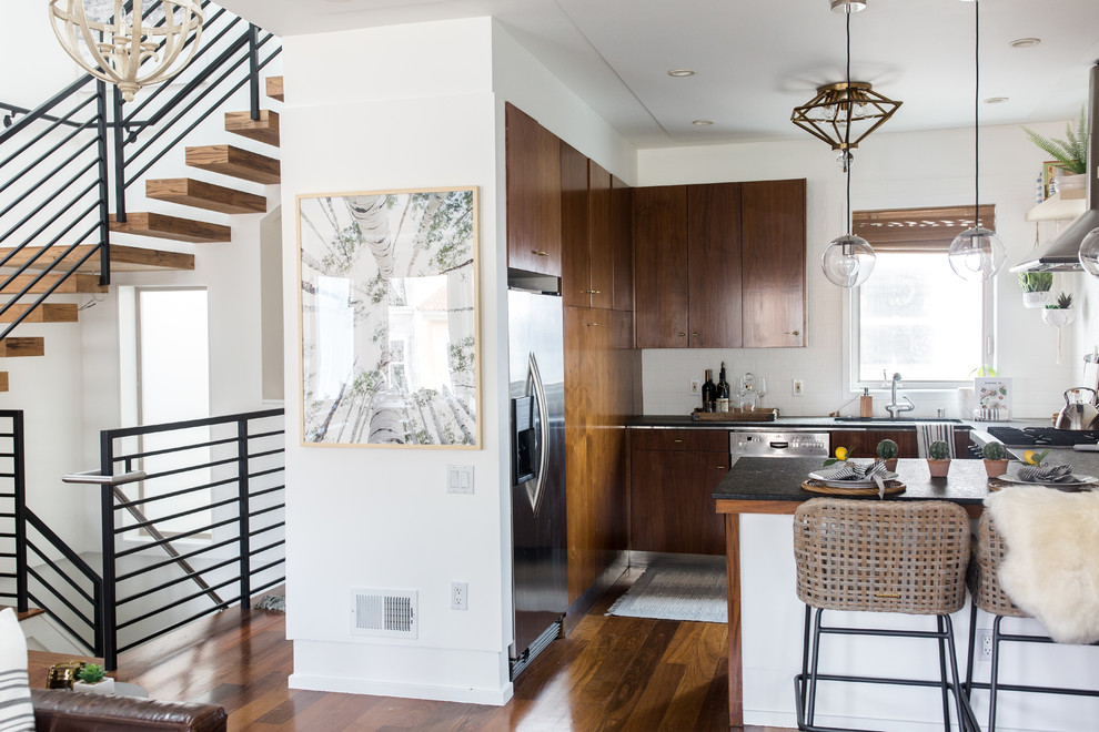 Inspiration for a mid-sized eclectic l-shaped dark wood floor and brown floor open concept kitchen remodel in San Francisco with a single-bowl sink, flat-panel cabinets, brown cabinets, concrete countertops, white backsplash, subway tile backsplash, stainless steel appliances and an island