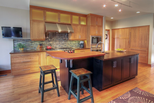 Example of a mid-sized classic u-shaped medium tone wood floor kitchen pantry design in Philadelphia with a double-bowl sink, shaker cabinets, medium tone wood cabinets, wood countertops, multicolored backsplash, matchstick tile backsplash, stainless steel appliances and an island