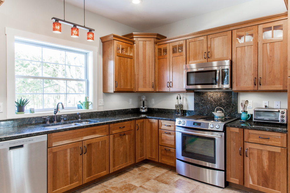 Inspiration for a mid-sized timeless l-shaped ceramic tile eat-in kitchen remodel in Burlington with an undermount sink, shaker cabinets, medium tone wood cabinets, granite countertops and stainless steel appliances