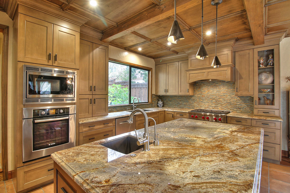 Example of a large eclectic l-shaped ceramic tile eat-in kitchen design in San Francisco with an undermount sink, shaker cabinets, brown cabinets, granite countertops, multicolored backsplash, stone tile backsplash, stainless steel appliances and an island