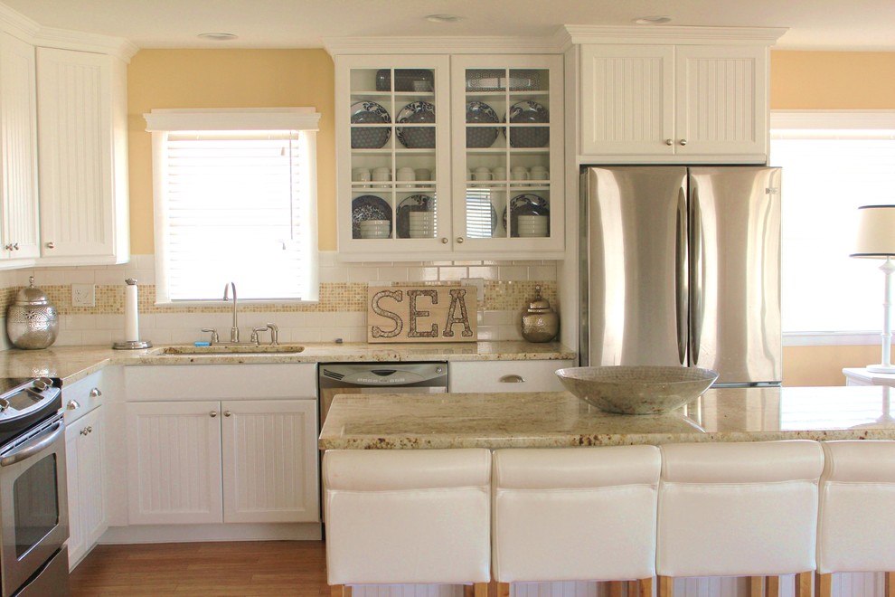 Photo of a small nautical l-shaped open plan kitchen in Philadelphia with a submerged sink, granite worktops, stainless steel appliances, bamboo flooring and an island.