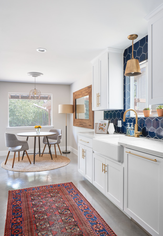 Einzeilige, Große Klassische Wohnküche mit weißen Schränken, Küchenrückwand in Blau, Rückwand aus Keramikfliesen, Kücheninsel, grauem Boden und weißer Arbeitsplatte in Austin