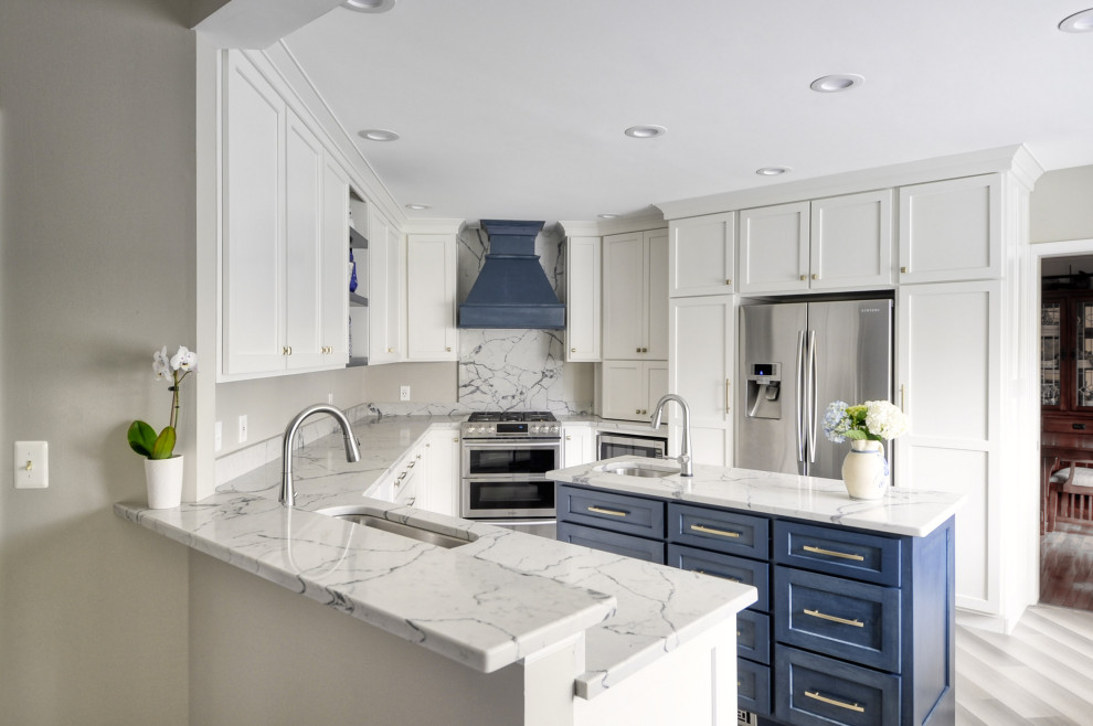 Mid-sized transitional u-shaped laminate floor and gray floor open concept kitchen photo in DC Metro with an undermount sink, shaker cabinets, white cabinets, quartzite countertops, stainless steel appliances, an island and white countertops