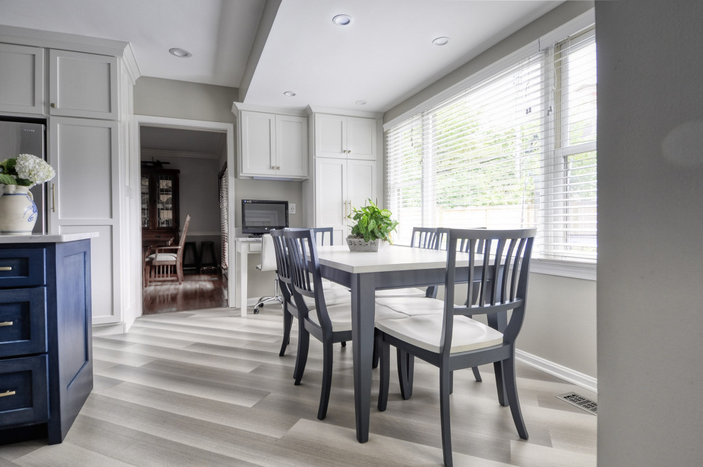 Open concept kitchen - mid-sized transitional u-shaped laminate floor and gray floor open concept kitchen idea in DC Metro with an undermount sink, shaker cabinets, white cabinets, quartzite countertops, stainless steel appliances, an island and white countertops