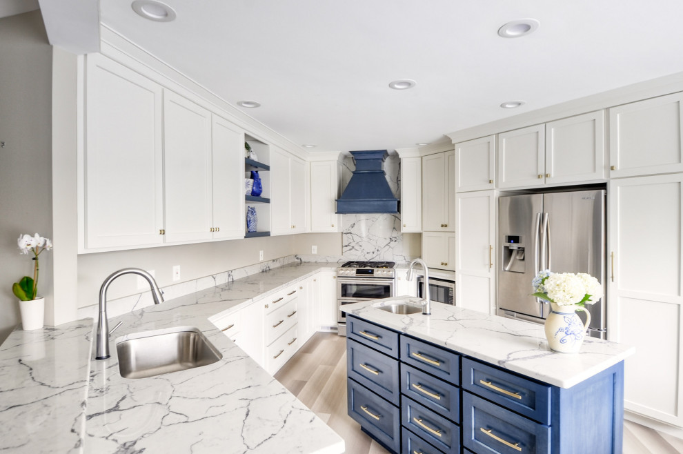 Inspiration for a mid-sized transitional u-shaped laminate floor and gray floor open concept kitchen remodel in DC Metro with an undermount sink, shaker cabinets, white cabinets, quartzite countertops, stainless steel appliances, an island and white countertops
