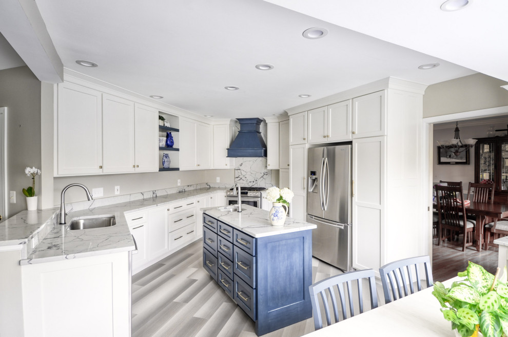 Mid-sized transitional u-shaped laminate floor and gray floor open concept kitchen photo in DC Metro with an undermount sink, shaker cabinets, white cabinets, quartzite countertops, stainless steel appliances, an island and white countertops