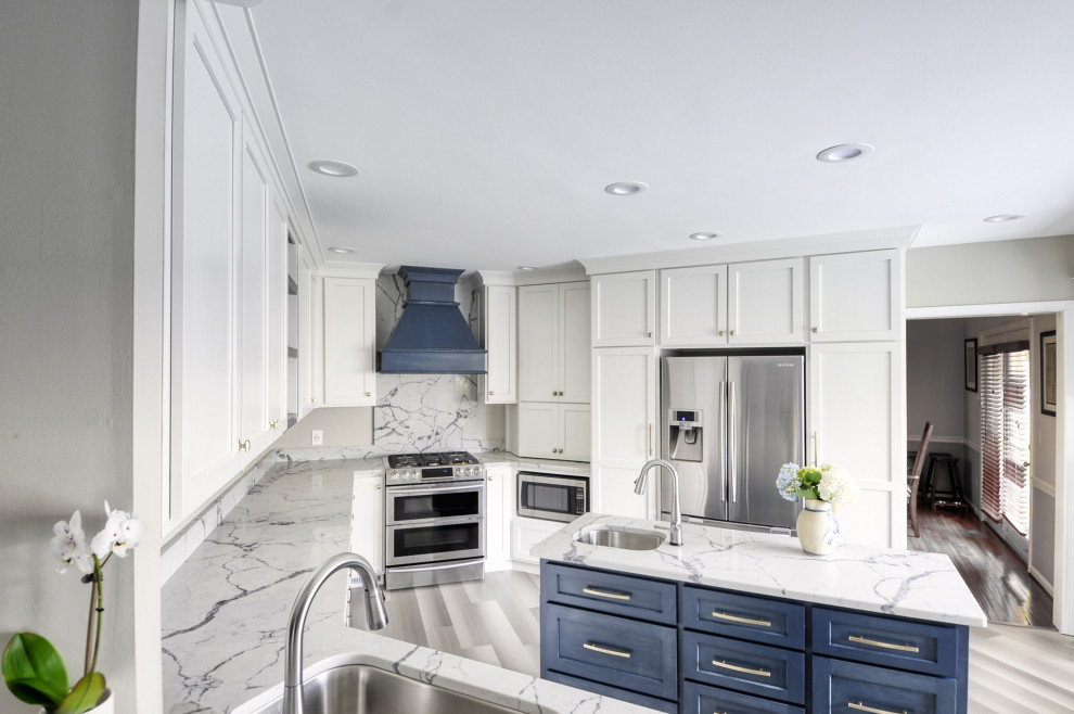 Mid-sized transitional u-shaped laminate floor and gray floor open concept kitchen photo in DC Metro with an undermount sink, shaker cabinets, white cabinets, quartzite countertops, stainless steel appliances, an island and white countertops
