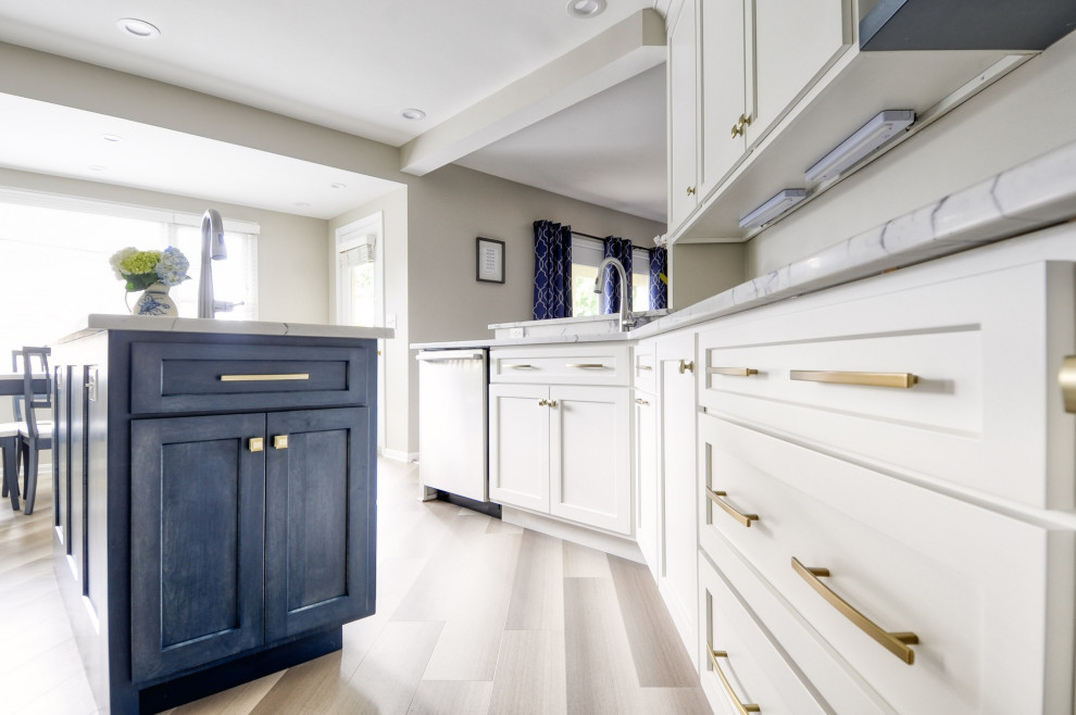 Open concept kitchen - mid-sized transitional u-shaped laminate floor and gray floor open concept kitchen idea in DC Metro with an undermount sink, shaker cabinets, white cabinets, quartzite countertops, stainless steel appliances, an island and white countertops