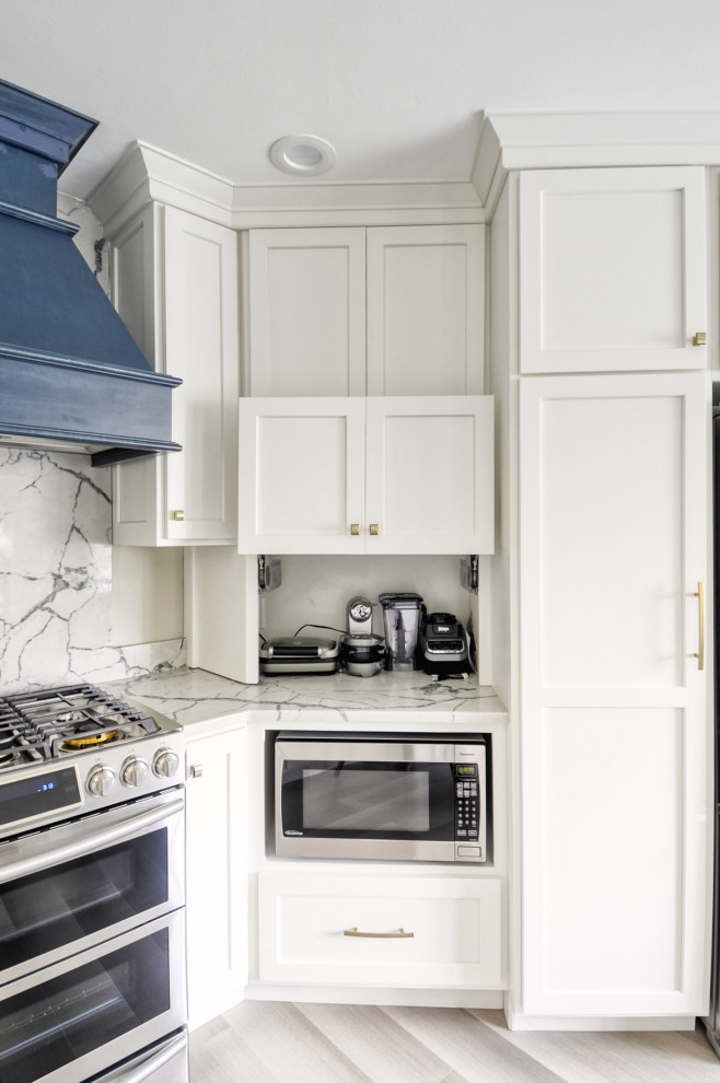 Mid-sized transitional u-shaped laminate floor and gray floor open concept kitchen photo in DC Metro with an undermount sink, shaker cabinets, white cabinets, quartzite countertops, stainless steel appliances, an island and white countertops