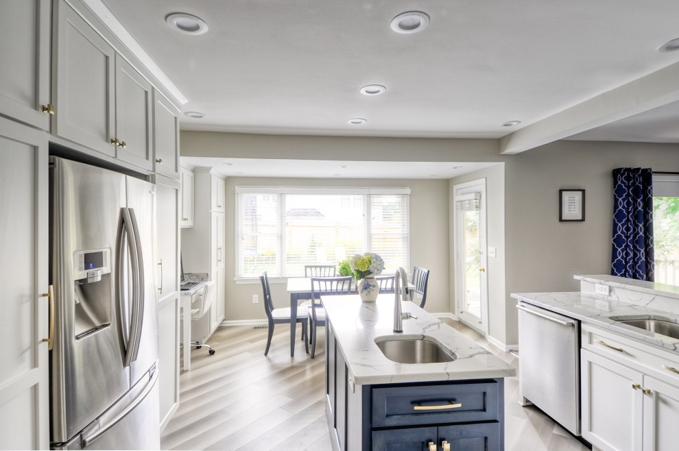 Mid-sized transitional u-shaped laminate floor and gray floor open concept kitchen photo in DC Metro with an undermount sink, shaker cabinets, white cabinets, quartzite countertops, stainless steel appliances, an island and white countertops