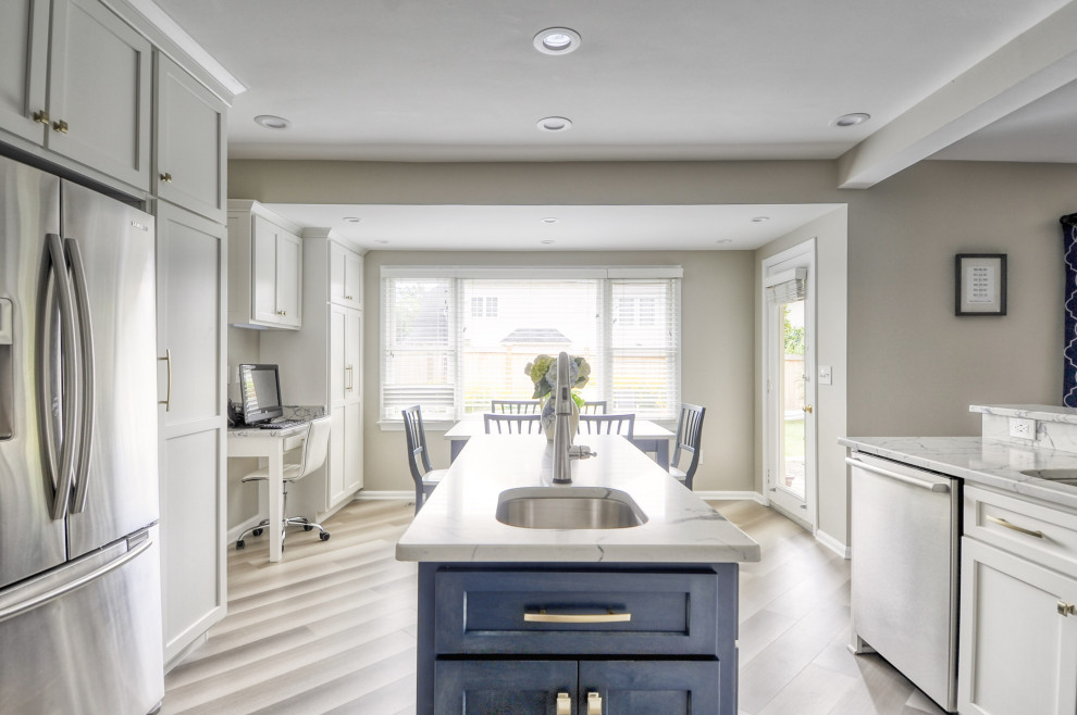 Mid-sized transitional u-shaped laminate floor and gray floor open concept kitchen photo in DC Metro with an undermount sink, shaker cabinets, white cabinets, quartzite countertops, stainless steel appliances, an island and white countertops