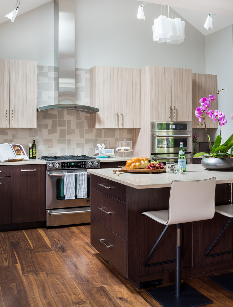 Bild på ett mellanstort retro kök, med en undermonterad diskho, släta luckor, skåp i ljust trä, bänkskiva i kvartsit, flerfärgad stänkskydd, stänkskydd i porslinskakel, rostfria vitvaror, mellanmörkt trägolv och en köksö